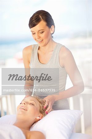 Woman giving scalp massage outdoors