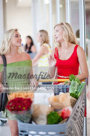 Women pushing shopping cart