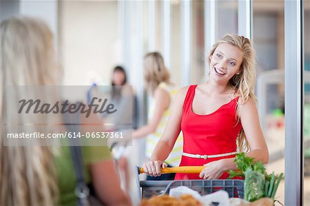 Women pushing shopping cart