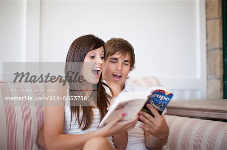 Couple reading travel book together