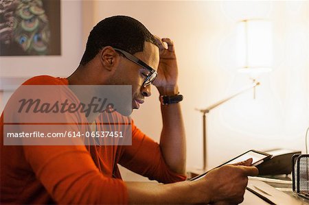 Man using tablet computer at desk