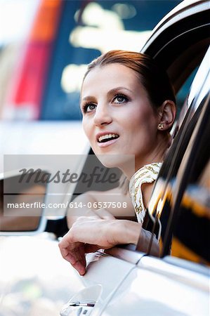 Woman looking out car window