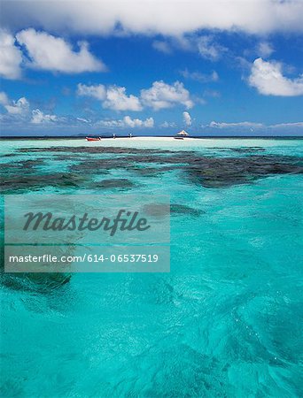 Clouds over sandbar and tropical water