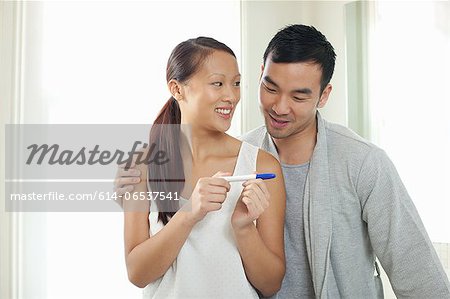 Couple taking pregnancy test in bathroom