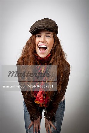 Laughing woman leaning on knees Laughing woman leaning on knees