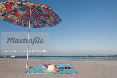 Blanket and towel on empty beach Blanket and towel on empty beach