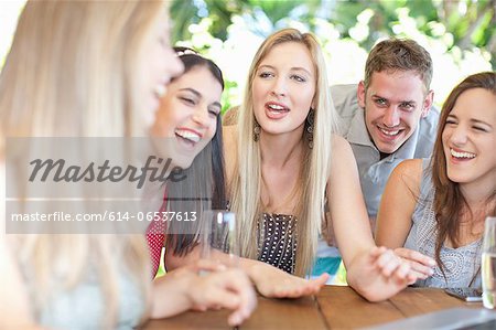 Group of friends talking at table