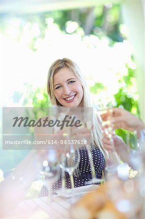 Woman toasting with champagne at table Woman toasting with champagne at table