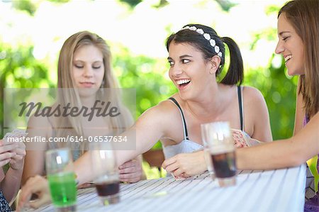 Women playing cards at table