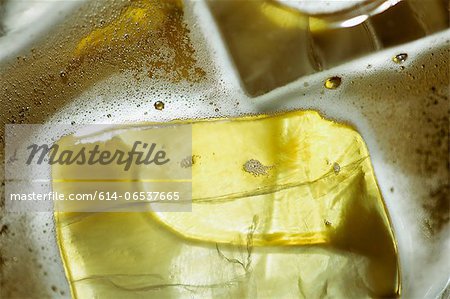Close up of ice cubes in glass of beer