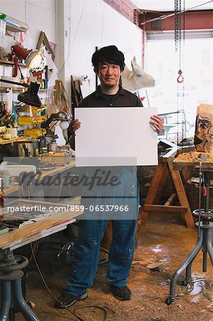 Sculptor holding a white board
