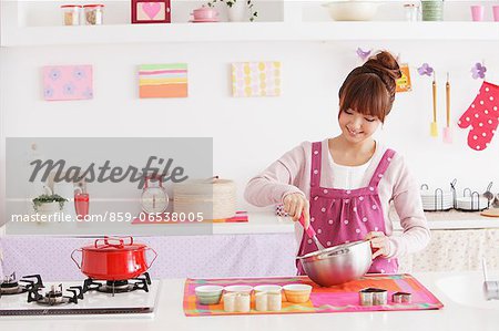 Young woman cooking in a kitchen