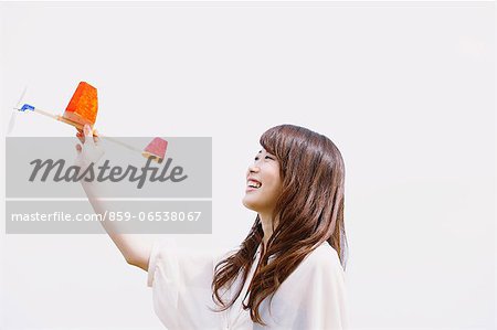 Young woman with toy airplane