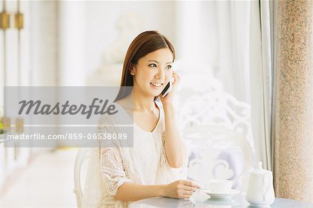 Young woman on the phone in a cafe