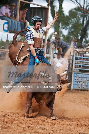 Australia, Queensland, Mt Garnet.  Bull rider in action at Mt Garnet Rodeo.