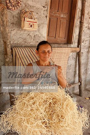 South America, Brazil, Maranhao, Barreirinhas, woman weaving buriti palm thread near Barreirinhas in the Lencois Maranhenses
