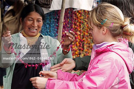 Girl shopping for necklaces at Otavalo Market, Ecuador