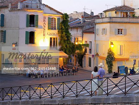 France, Provence, Arles, Couple on steps infront of cafe. MR