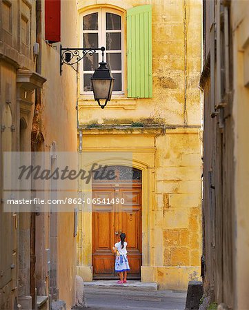 France, Provence, Arles, girl with Baguette at doorway MR