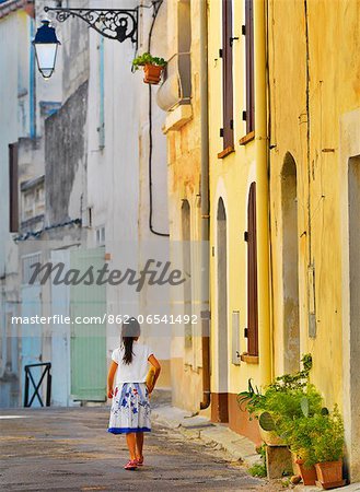 France, Provence, Arles, girl with Baguette walking up alleyway, MR, France, Provence, Arles, girl with Baguette walking up alleyway, MR,