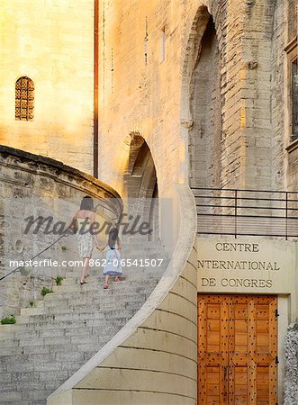 France, Provence, Avignon, Palais de Papes, Woman and girl walking up stairway MR