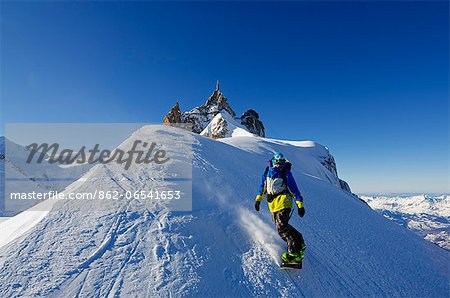 Europe, France, French Alps, Haute Savoie, Chamonix, Aiguille du Midi, snowboarder starting the Vallee Blanche off piste