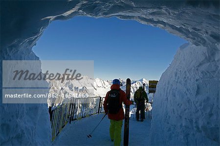 Europe, France, French Alps, Haute Savoie, Chamonix, Aiguille du Midi, skiers exiting tunnel for Vallee Blanche