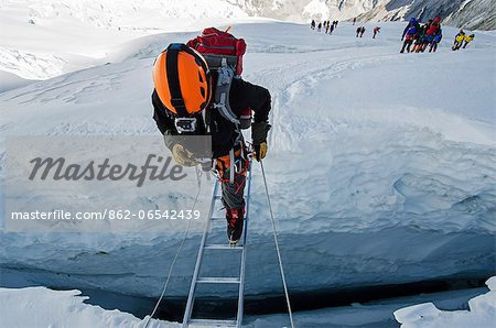 Asia, Nepal, Himalayas, Sagarmatha National Park, Solu Khumbu Everest Region, the Khumbu icefall on Mt Everest, climbers crossing ladders over a crevasse