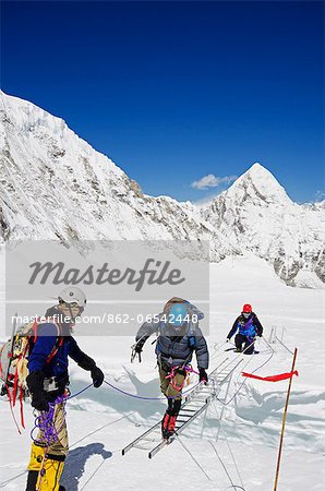 Asia, Nepal, Himalayas, Sagarmatha National Park, Solu Khumbu Everest Region, climbers crossing ladders over a crevasse