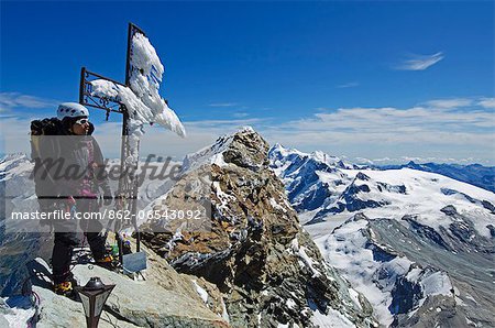 Europe, Switzerland, Swiss Alps, Valais, Zermatt, cross and climber on summit of The Matterhorn , 4478m, MR,