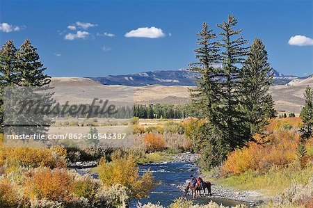 Cowboys along Wind River, near Dubois, Wyoming, USA