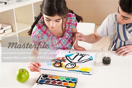 Girl and Boy Painting in Classroom