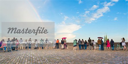 People Standing along Wall at Kaiserburg Castle Looking at Cityscape with Rainbow in Sky, Nuremberg, Mittelfranken, Middle Franconia, Bavaria, Germany