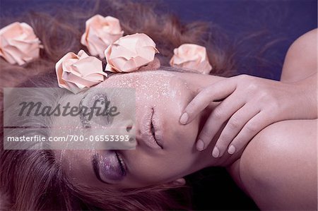 Woman Lying Down with Powder and Paper Roses on Face