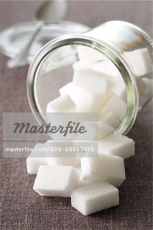 Close-up of Jar of Sugar Cubes Spilling