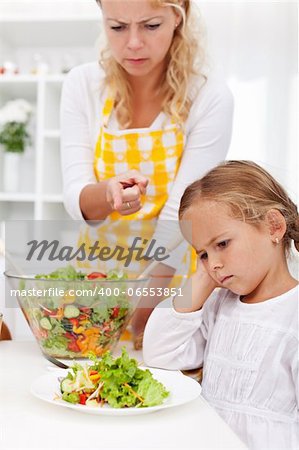 Eat your veggies right now - mother pointing her child in the right direction