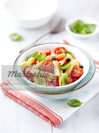 bowl of penne pasta with roasted cherry tomatoes and capers