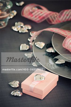 Restaurant series. Valentines day dinner with table setting in pink and gray and holiday elegant heart ornaments