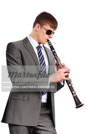 Young musician with sunglasses playing the clarinet on a white background
