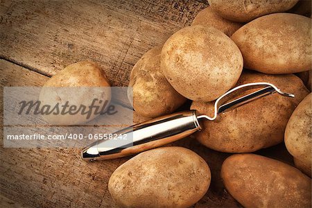 Harvest potatoes on wooden background