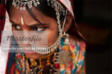 Portrait of Traditional Indian woman in sari costume covered her face with veil, India