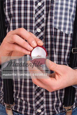 Man holding red box with wedding ring