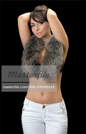 Pretty young brunette in fur. Isolated on black