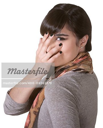 Coy Hispanic female hiding part of face with hand