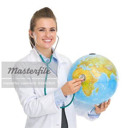 Happy medical doctor woman listening globe with stethoscope