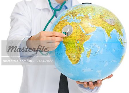 Closeup on medical doctor woman listening globe with stethoscope