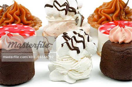 Arrangement of Cakes with Chocolate Cupcakes,  Tartlet, Strawberry Jelly Cheesecake Polka Dot, Dark Chocolate Glazed Meringue and Sponge Cake. Lateral view