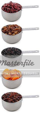 A variety of dried fruit - cranberries, sultanas, currants, apricots and raisins - in cup measures, isolated on a white background