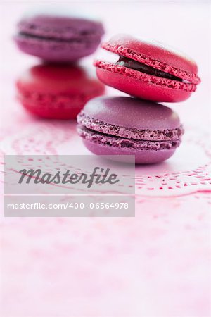 Closeup of two stacks of sweet macaroons on pink mat