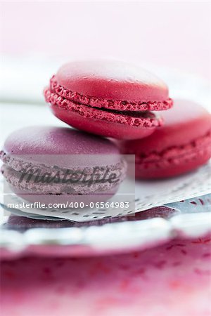 Closeup of three sweet macaroons on white decorative mat